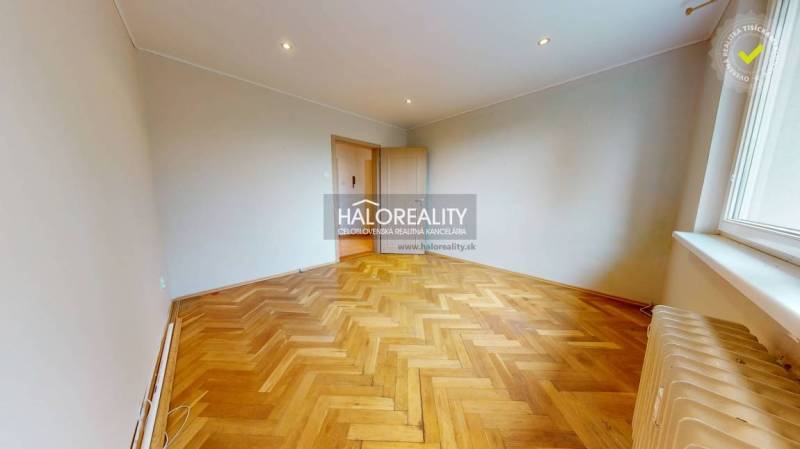 A spacious room with parquet flooring and a window in a 3-room apartment.