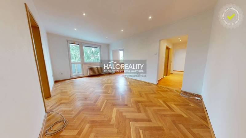 An airy living space with wooden flooring in a 3-room apartment.