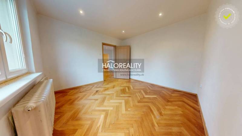 A spacious room with wooden parquet floors in a 3-room apartment for sale.