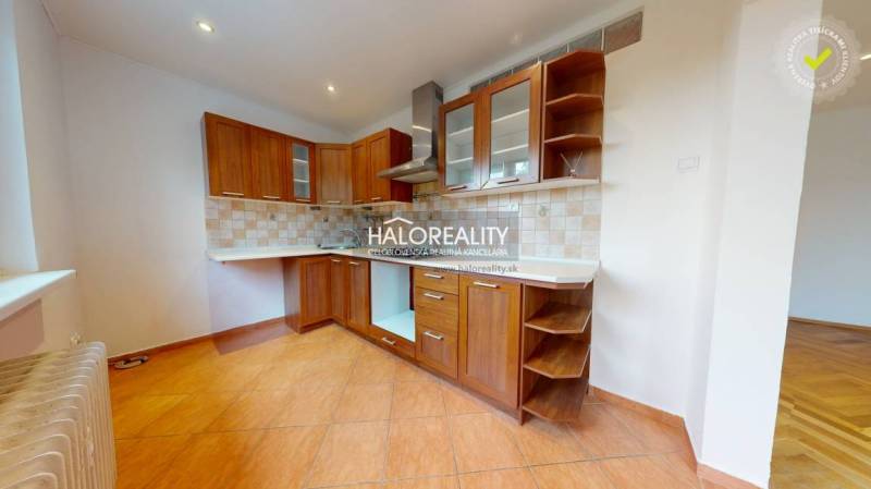 A kitchen in a 3-room apartment with a wooden cabinet and ceramic tiles.