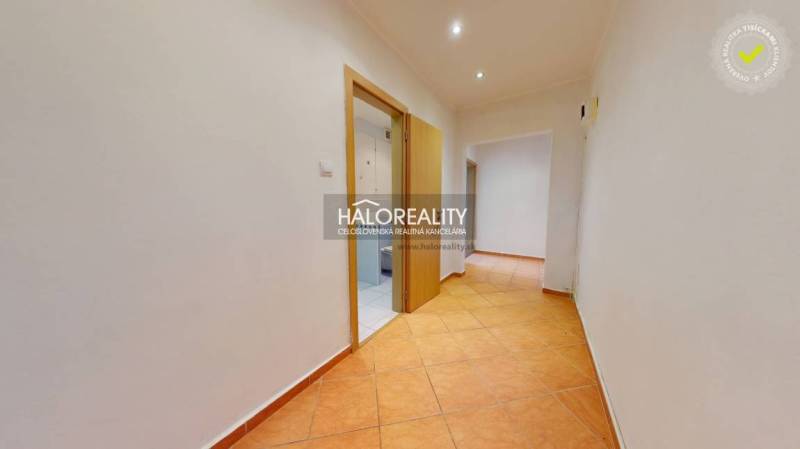 Tiled hallway in a 3-room apartment with white walls and built-in lights.
