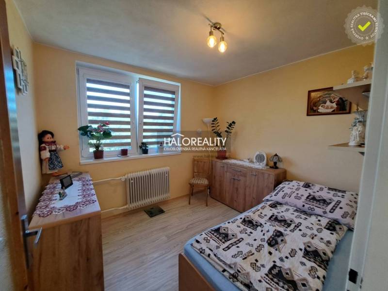 Bedroom in a family house with wooden furniture and houseplants.