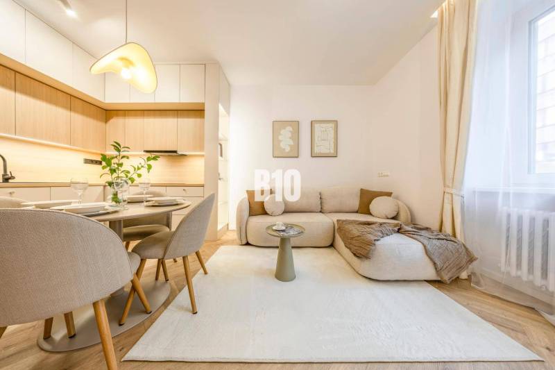 A bright living room on Benediktiho Street in a 3-room apartment, including a kitchen and dining area.