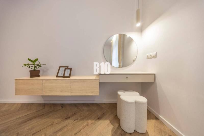 A minimalist interior with white furniture and decorations in a 3-room apartment on Benediktiho Street.