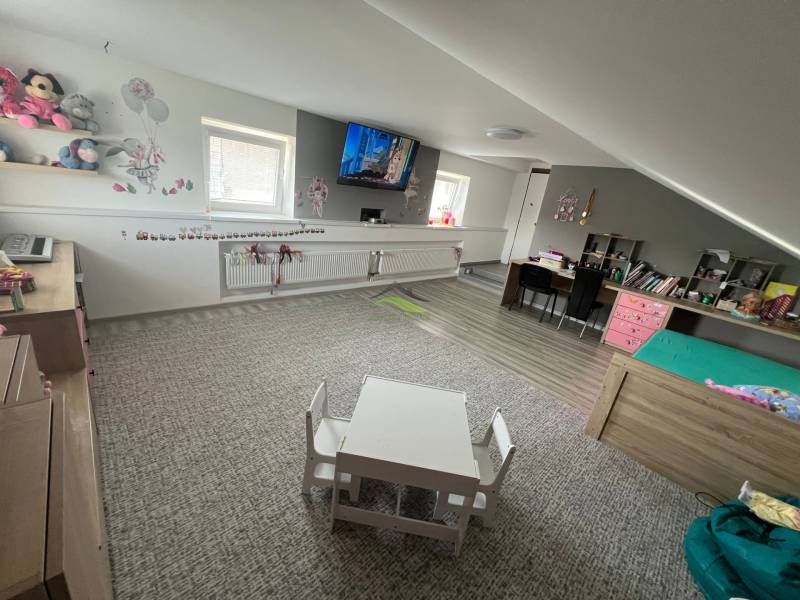 Children's room in a family house with toys, a table, and cozy furniture.