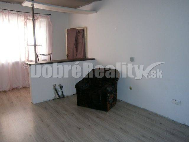 Interior of a family house with an armchair and a counter, laminate flooring, furnishings.