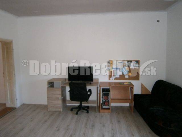 Interior of a family house with a table, chair, and sofa, bright space.