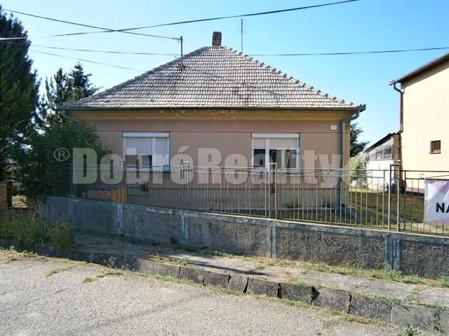 A family house in Rúbaň with a simple facade, a sloped roof, and a front garden.