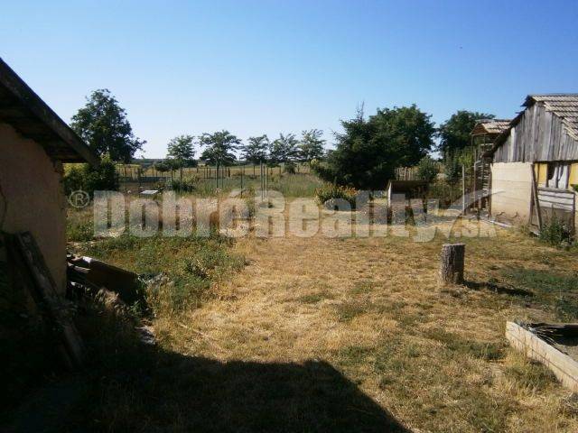 A garden at a family house in Rúbaň with a lawn and surrounding cultivation possibilities.