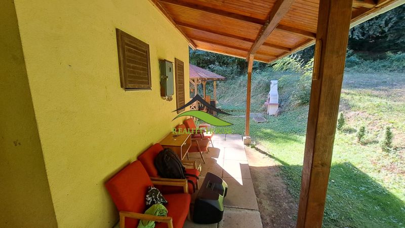 Covered terrace of the cottage on Dobrá Street in Kvakovce with seating and an outdoor fireplace.