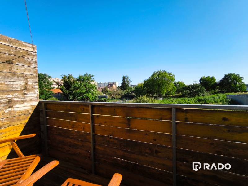 Wooden balcony with a view of greenery in a 2-room apartment on Pri Maline Street, Malacky.
