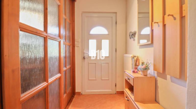 A hallway with wooden furniture and doors in a family house.