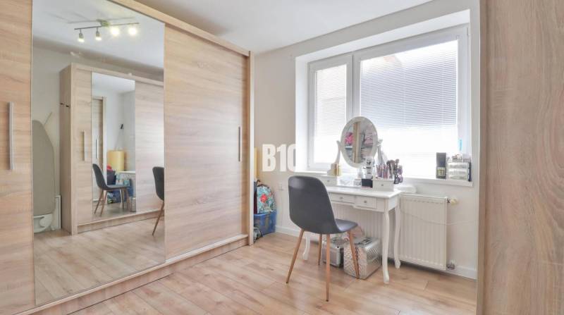 Wardrobe and dressing table in the interior of a family house with a large mirror and spacious closet.