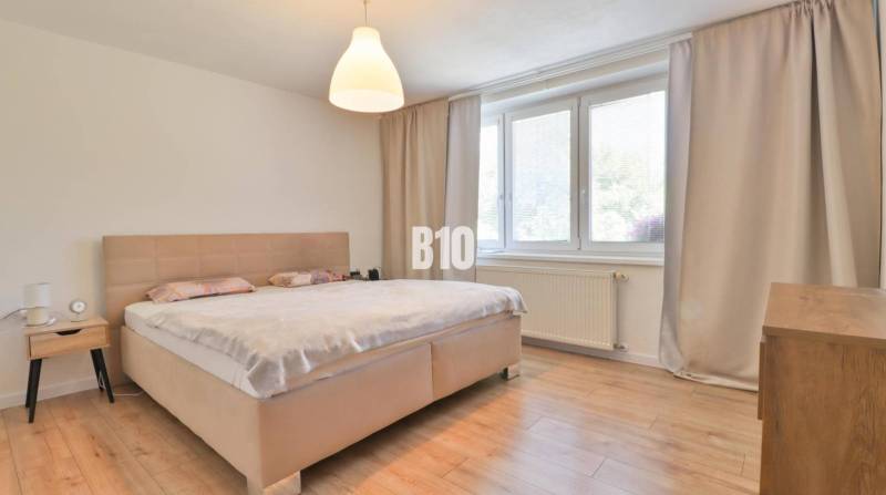Bedroom in a family house with a large bed and minimalist furniture.