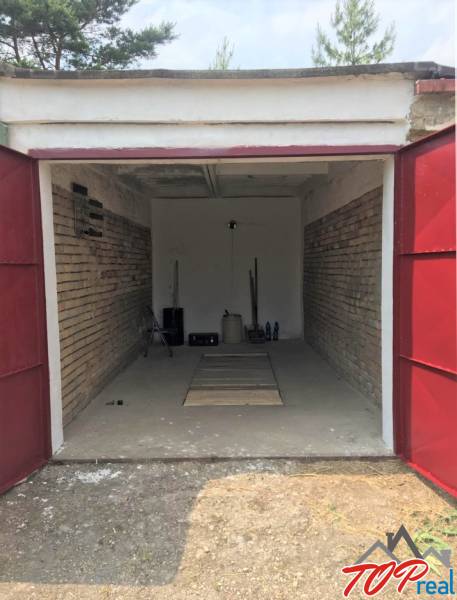 Open garage with brick walls on Michalovská Street, Košice - Západ district.