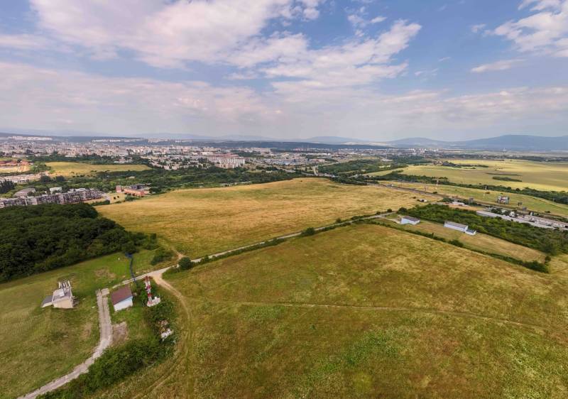 Aerial view of agricultural and forest lands with the city of Košice, district Luník IX.