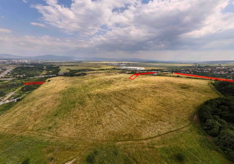 Agricultural and forest lands spread out in Košice, Luník IX district, under the clouds.