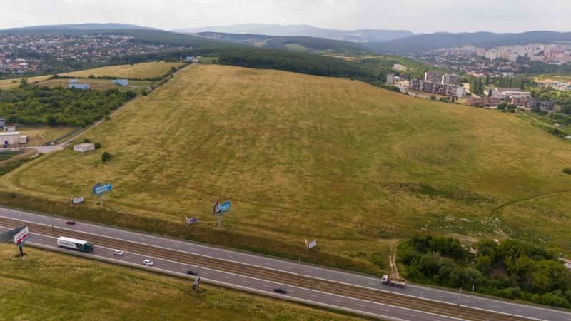 Extensive agricultural and forest lands in Košice, Luník IX district, with a highway.