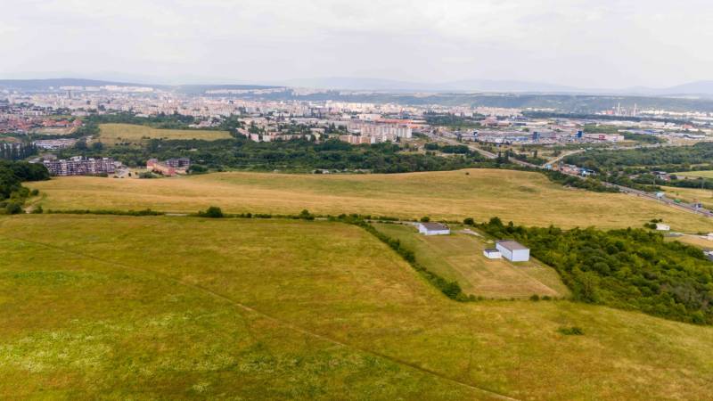 Agricultural and forest lands in Košice, Luník IX district, with the city in the background.