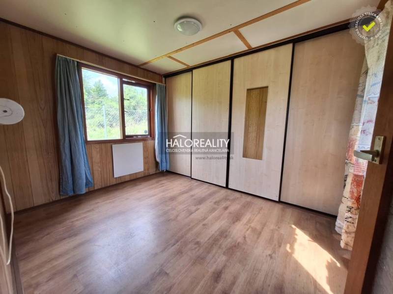 Chat room with light wooden walls, floor, and a large window.