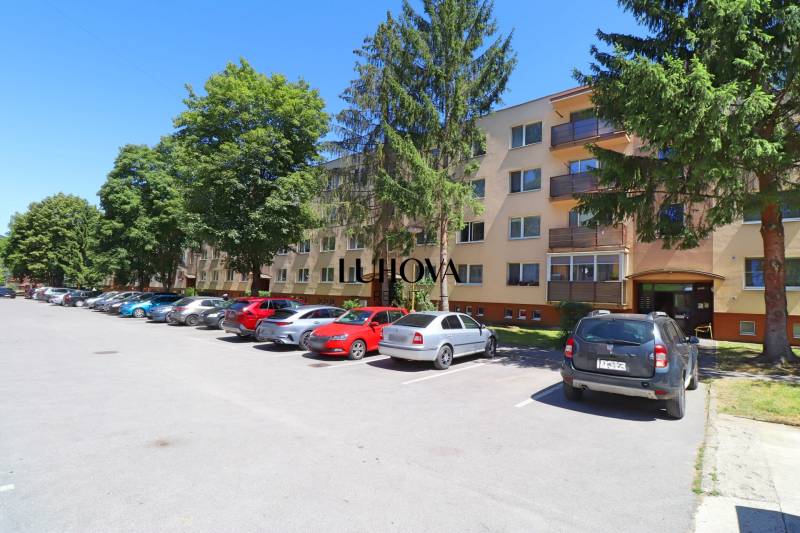 Apartment building on Hliny Street in Považská Bystrica with parking and greenery.