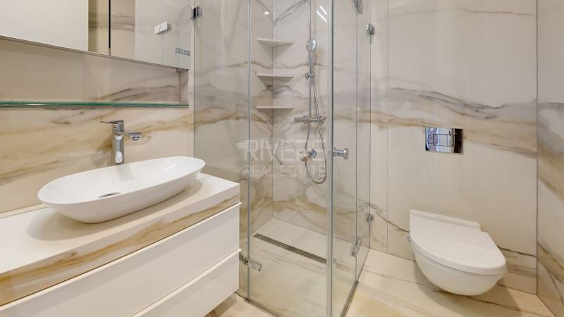 Luxury bathroom with a shower and designer sink in a 2-room apartment.