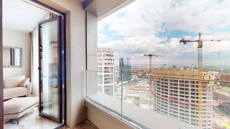 A balcony of a 2-room apartment with a view of towers and cranes in Bratislava - Old Town.