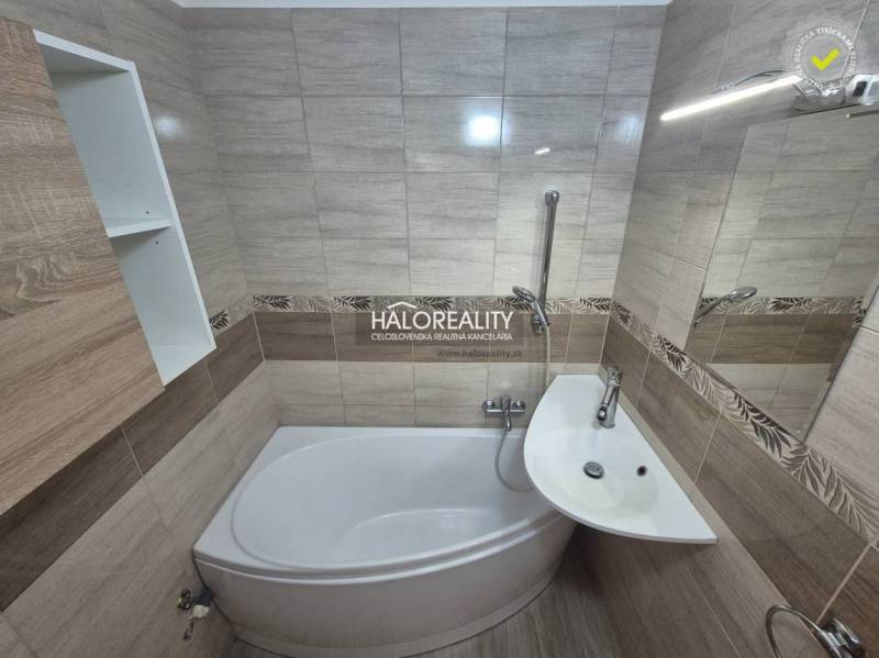 Bathroom with a shower tub and sink in a 3-room apartment, tiles with a natural pattern.