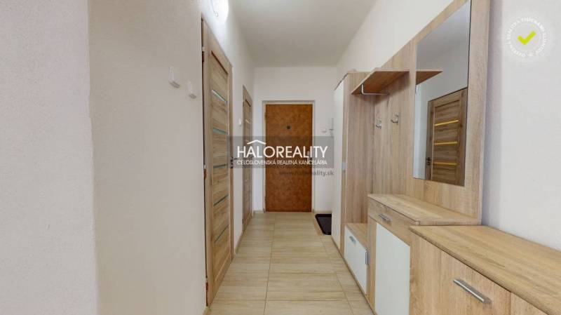Hallway in a 3-room apartment with wooden furniture and tiled floor.