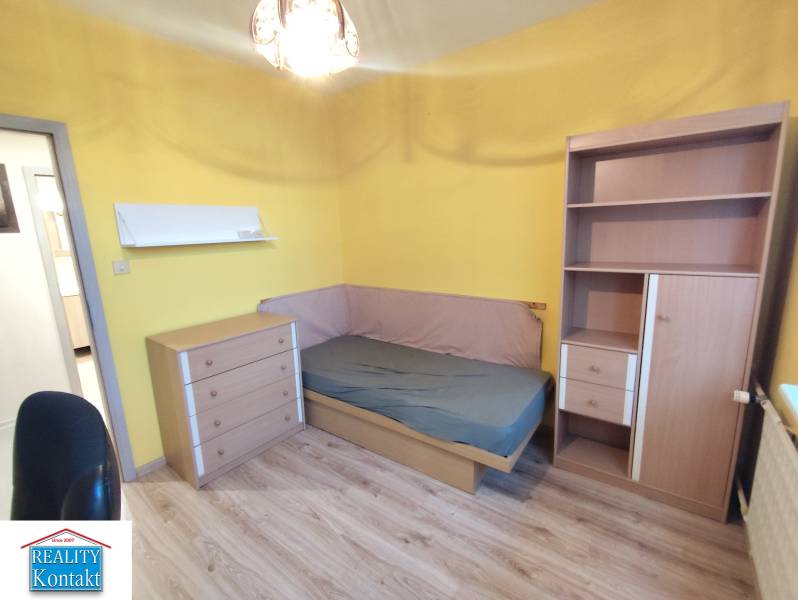 A cozy room with a bed and furniture in a 3-room apartment.