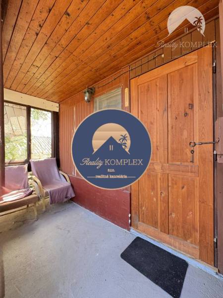 Wooden interior of a cabin with chairs and doors.