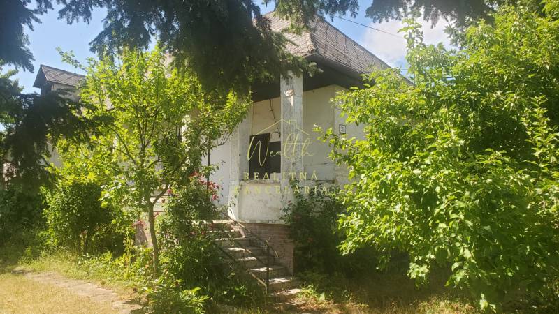 A family house on Mostová Street in Sečovce surrounded by greenery and trees.