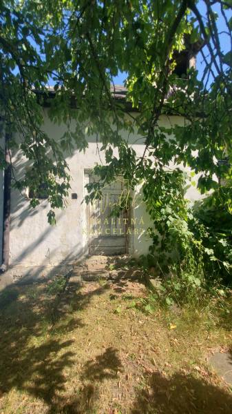 An older family house on Mostová Street in Sečovce, surrounded by greenery and trees.