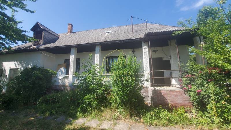 A family house on Mostová Street in Sečovce, with lush vegetation in front of the house.