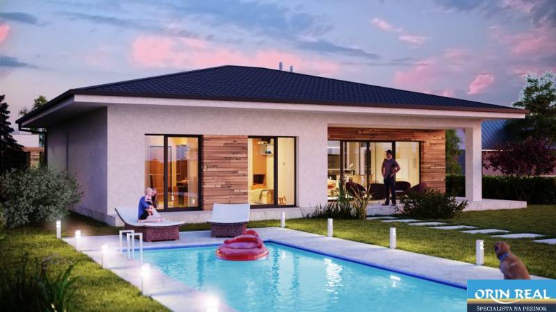 A cottage on Bratislavská Street in Pezinok with a pool and a terrace in evening lighting.