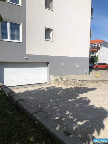 In Slovenský Grob on Rastislavova Street, there are garages near residential buildings.
