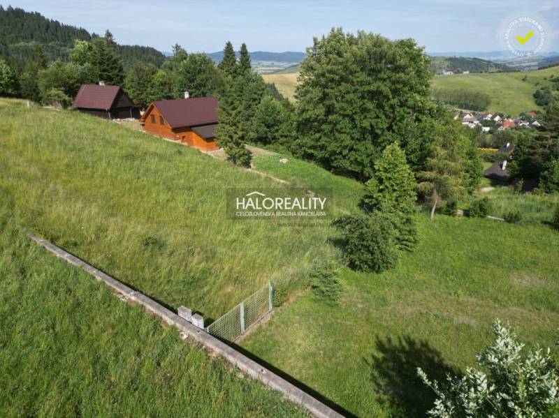Recreational plots in Vyšné Ružbachy with wooden cottages surrounded by greenery and hills.