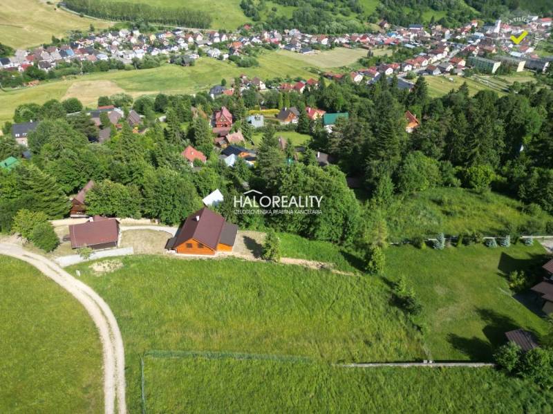 Aerial view of recreational plots in Vyšné Ružbachy surrounded by greenery and village houses.
