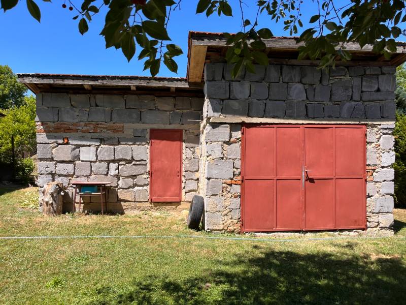 Stone shelter with red doors in the garden of a family house in Slovenská Kajňa.