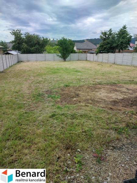 A plot of land with a lawn surrounded by a fence on Nezabudova Street in Sabinov, ideal for a family house.