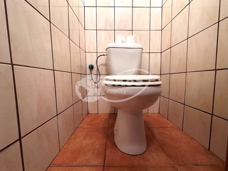 A bathroom in a 3-room apartment with tiles on the walls and floor.