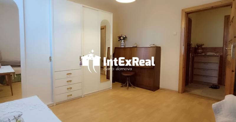 A room in a 3-room apartment with a wardrobe and a dressing table.