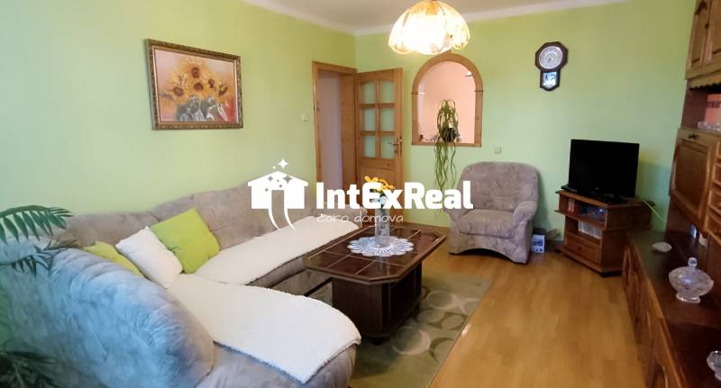 Living room with a sofa, table, and television in a 3-room apartment.