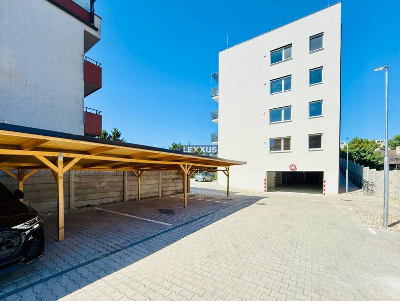 Parking lot and apartment building on Geologická Street in Bratislava - Podunajské Biskupice.