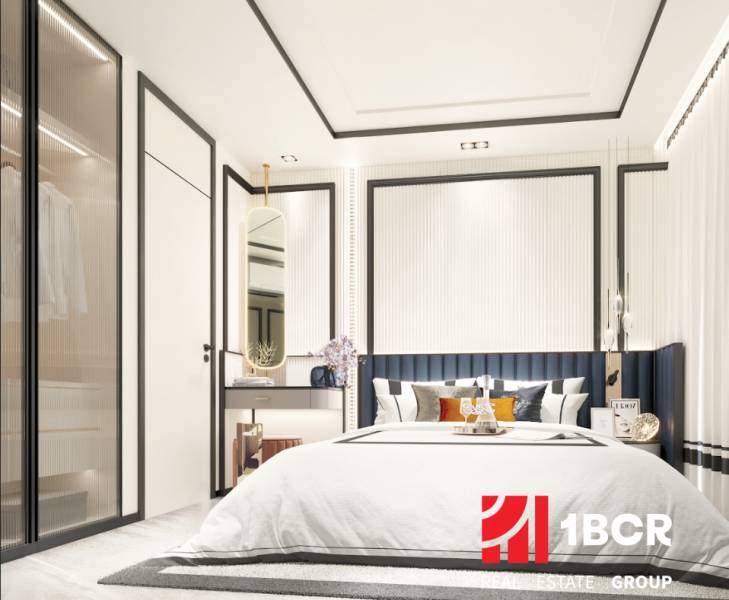 A bedroom in a 2-room apartment with a large bed, a wardrobe, and a mirror.