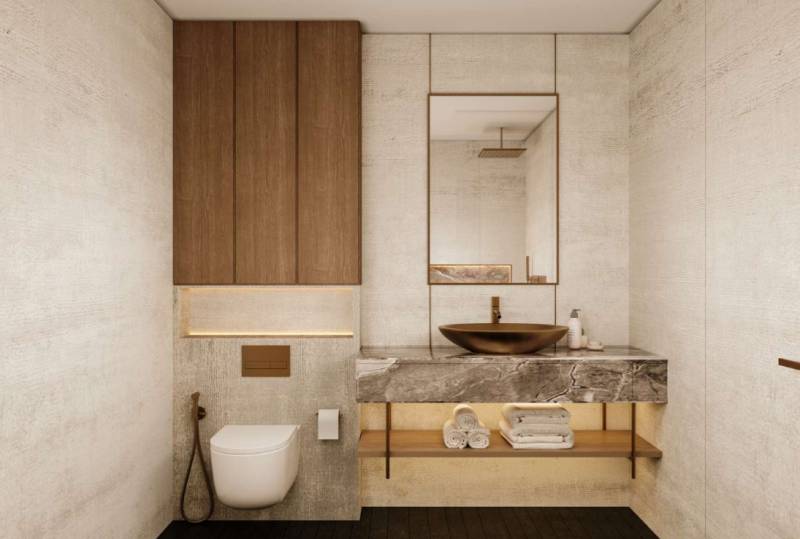A minimalist bathroom in a family house with a stone sink and toilet in neutral tones.