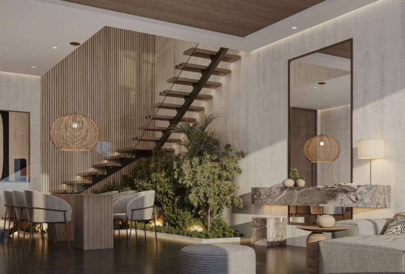 Interior of a family house with a staircase, dining table, and designer lights.