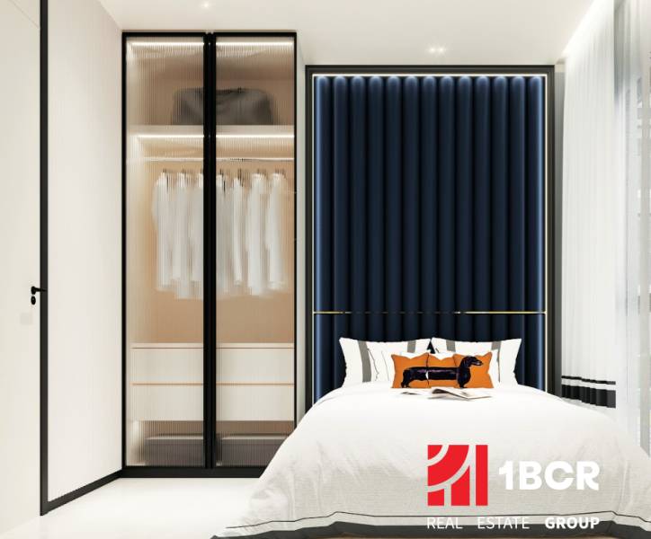 Stylish bedroom with a spacious wardrobe and bed in a 3-room apartment.