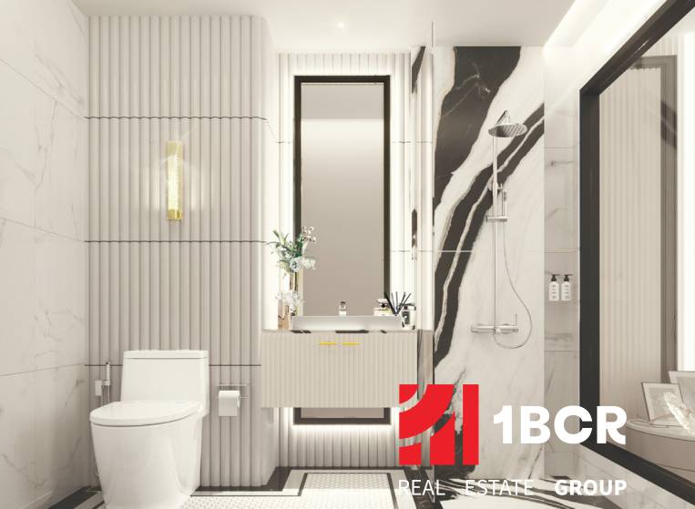 A bathroom in a 3-room apartment with marble tiles and a large mirror.