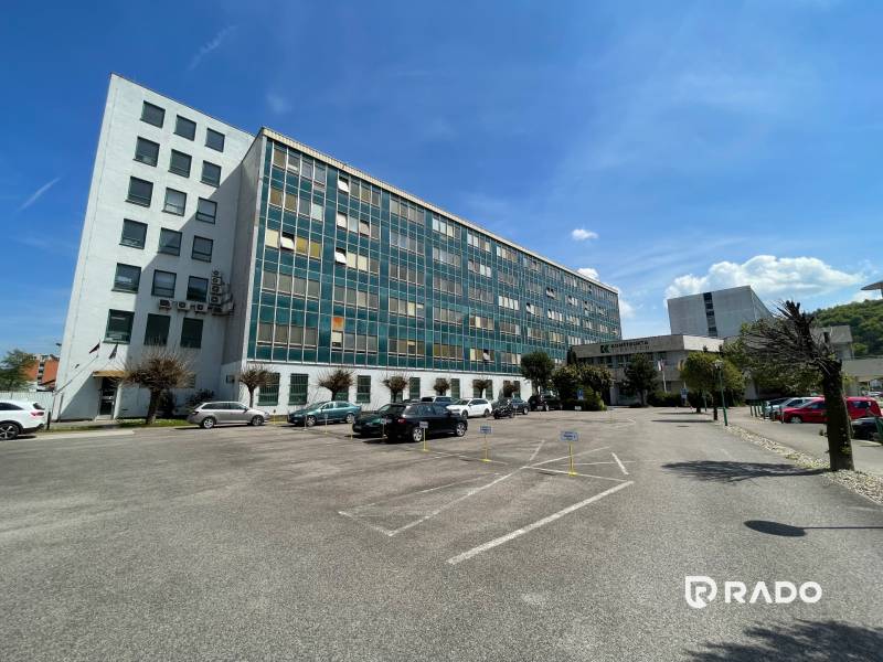 Office building on K výstavisku Street in Trenčín, parking lot with cars.